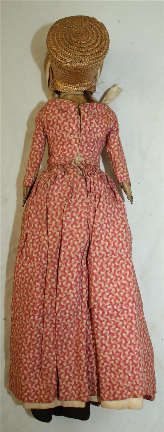 An early 19th century poured wax head and shoulder doll, 14in.